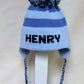 STRIPE EARFLAP WITH NAME AND POMPOM