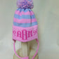 STRIPE EARFLAP WITH MONOGRAM BOWS AND POMPOM