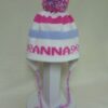 THREE STRIPE EARFLAP WITH NAME BOWS AND POMPOM