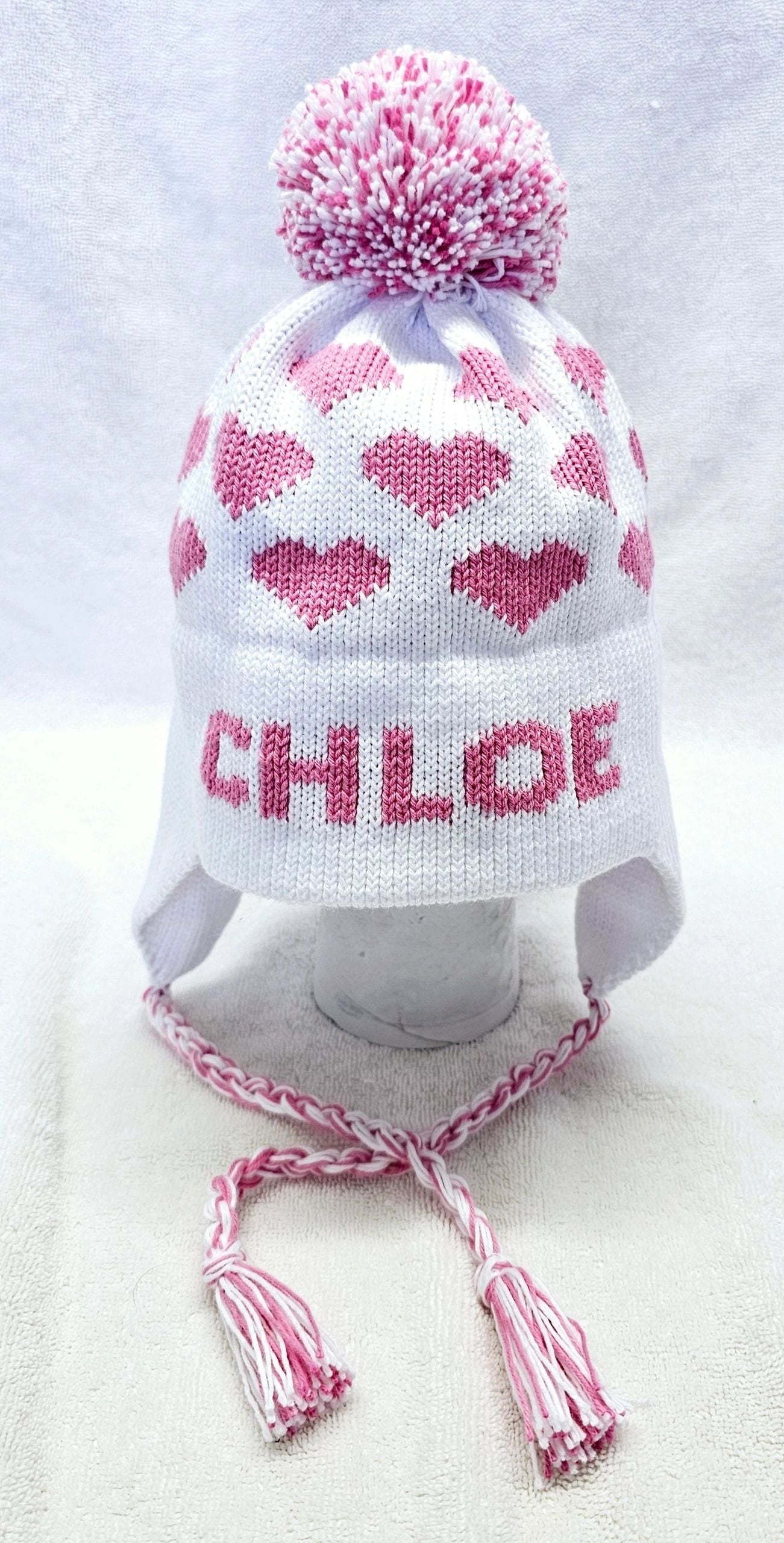 EARFLAP HAT WITH DESIGN AND POMPOM